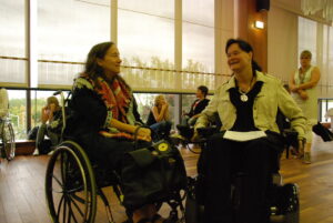 Vibeke Marøy Melstrøm and Jamie Bolling smiling and talking to each other during the Freedom Drive event in 2019. 