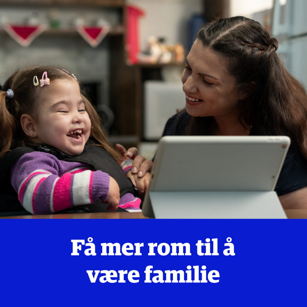 En liten jente og en voksen ser på et nettbrett mens de ler.